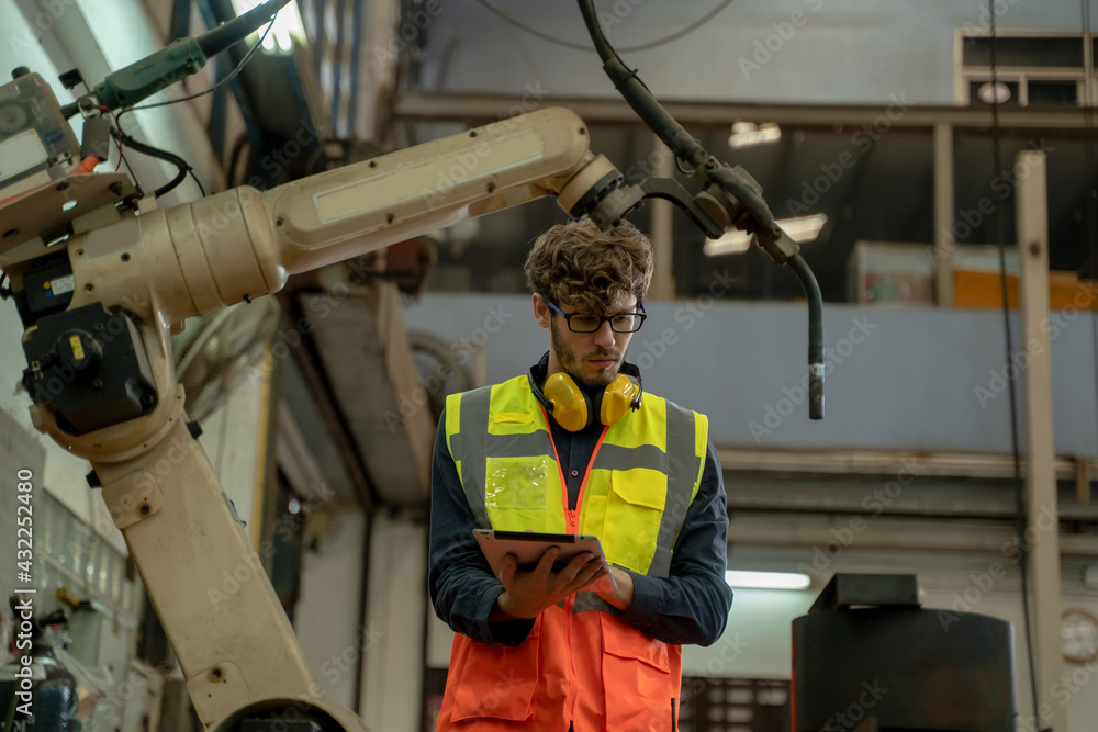 Poster engineer factory control and checking the robot working in factory workplace.