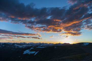 Dramatic colorful sunset and clouds over Rocky Mountain National Park mountain range, Colorado