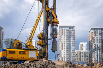 Hydraulic drilling rig for Installing a bored piles with a casing string on a construction site. Construction of drilled piles for the high-rise building foundation © hodim