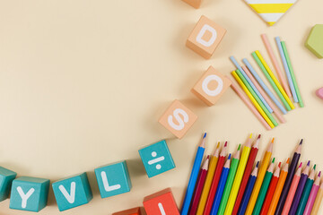 Multicolored wooden fractions, cubes, numbers on wooden table. Trendy puzzle toys. Geometric...