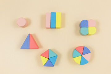Multicolored wooden fractions  on wooden table. Trendy puzzle toys. Geometric shapes. Back to...