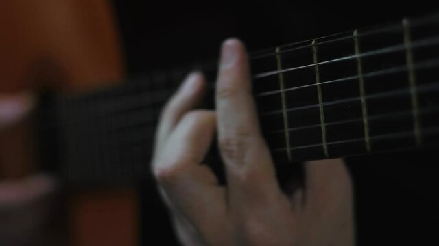 Playing a classic guitar, fingerboard view
