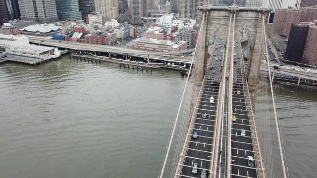 slow motion overhead aerial Brooklyn Bridge with cars driving across in New York City NYC