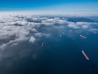 Naklejka na ściany i meble Stock aerial photo of scattered clouds over English Bay dotted with freighters, Canada