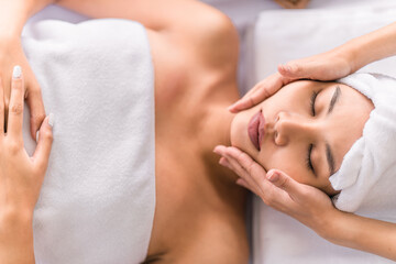 Fototapeta na wymiar asian woman getting facial spa massage treatment at beauty spa salon