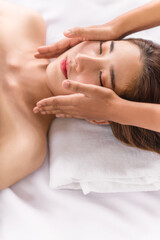 Fototapeta na wymiar woman getting facial spa massage treatment at beauty spa salon