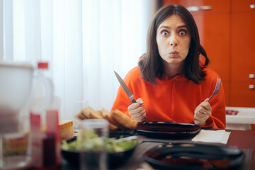 Hungry Woman Holding Fork and Knife Waiting for Dinner - obrazy, fototapety, plakaty