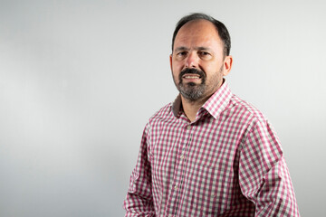 bearded worker man in plaid shirt looking at camera