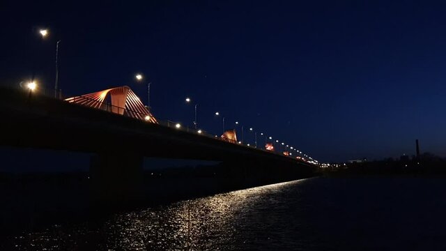 Southern Bridge lit at Daugava River Riga Latvia wide shot 