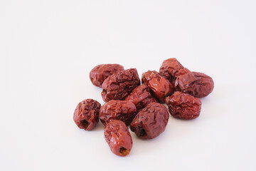 Red dates or red jujubes isolated on white background. Selected focus.

