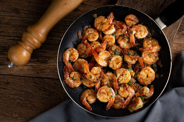 Delicious grilled prawns on wooden background.
