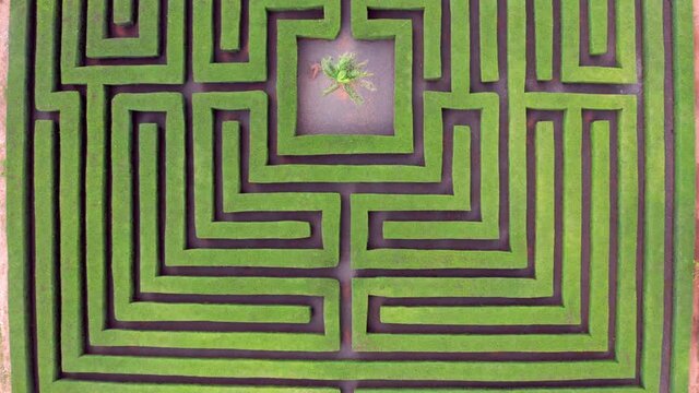 Aerial top-down forward over geometric labyrinth