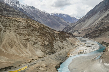 Aerial view of a river meeting another river with different color at a sangam in Indus Valley in Ladakh.