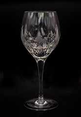 Empty crystal glass for wine on black background. Engraving vintage style, Selective focus.