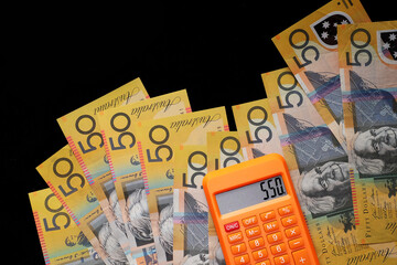 Close up of Australian Fifty banknotes against black background