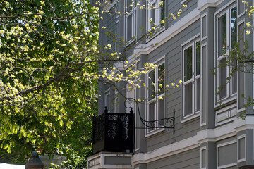 Black cast balcony  over a small patio in Fairhaven