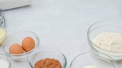 Chocolate cake recipe. Ingredients close up on kitchen table
