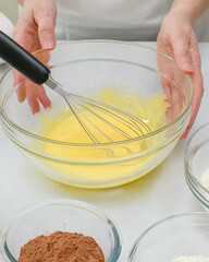 Whisk egg yolks with sugar in a glass bowl. Step by step chocolate cake recipe