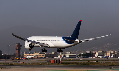 Fototapeta na wymiar Airplane lands at the airport of Barcelona. Spain