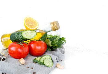 Fresh vegetables with olive oil set. Olive oil, garlic, dill, parsley, spices on white background.