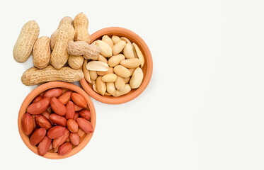 variety of peeled and roasted peanuts in shell. top view with copy space