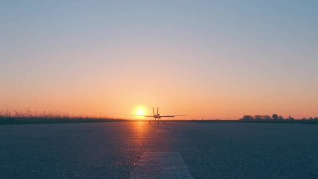 The testing flight of a new avia model on beautiful sunset background