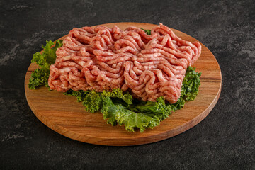 Raw pork minced meat over board