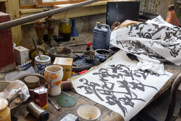 Old wooden table with Chinese calligraphy & various related vessels