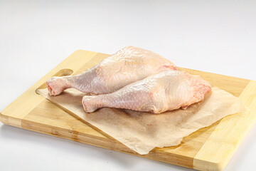 Raw chicken leg over background