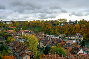 Fototapeta na wymiar A panoramic view on the Bern city and river from Muensterplatform on an autumn cloudy day