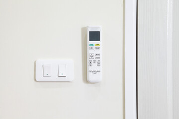 Remote control for air conditioner and power switch hang on the wall