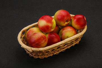 Sweet small nectarines in the basket