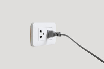 Gray plug in electric cord to a plastic electric socket