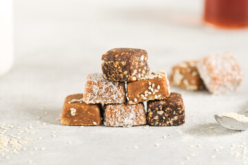 Stack of handmade vegan desserts made of dried fruits. Healthy raw vegetarian candies without sugar.
