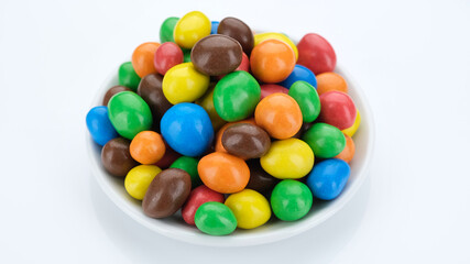 Fototapeta na wymiar Multicolored candy balls on white background. Assorted colorful chocolate candies