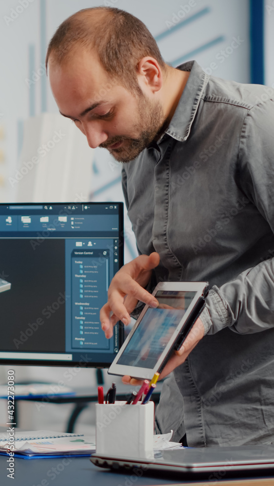 Poster industrial designer holding tablet discussing with woman engineer while working in cad program, desi