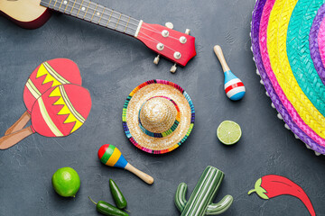 Composition with sombrero, guitar, maracas and drawn symbols of Mexico on dark background