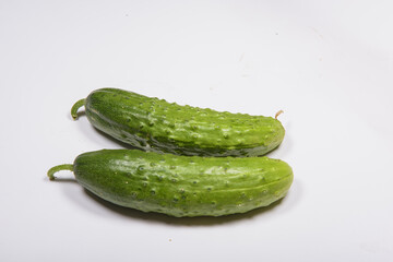 Two cucumbers on a white background