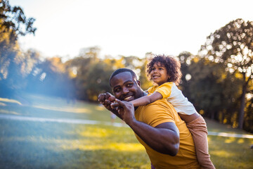 African American father and daughter having fun outdoors. - 432275683