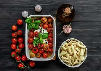 Trending viral Feta baked pasta recipe made of cherry tomatoes, feta cheese, garlic, and herbs in a...