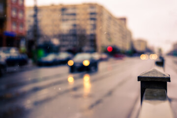 Rainy day in the big city, the headlights of the approaching car. Defocused image