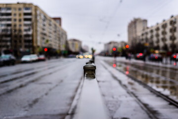 Rainy day in the big city, the empty road. Close up view, from the handrail on the sidewalk level