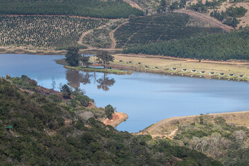 Obraz premium Water Reservoir Surrounded by Natural Rural Vegetation