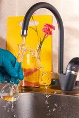 water purification specialist tap water pours into a glass flask.