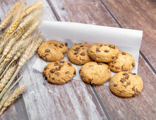 cookies and dried wheat on a wooden background