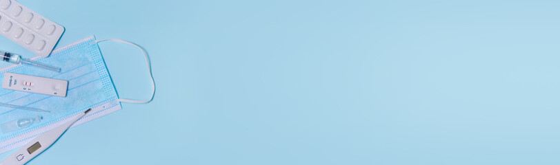 Express COVID-19 test,Schnelltest, medical mask, syringe,thermometer,medicine on a blue...