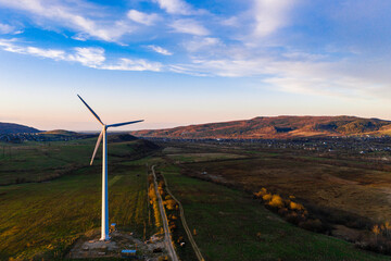 Panoramic landscape from the country road to the wind turbine, the development of wind energy in Ukraine.