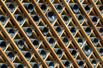 Wine bottles background. Bottles of red and white wine in a wine cabinet of a liquor store