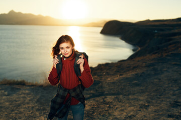 cheerful woman tourist with backpack travel freedom walk landscape