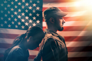 Memorial day, memorial day. The woman leans her head on the soldier's back, holding on to him with...